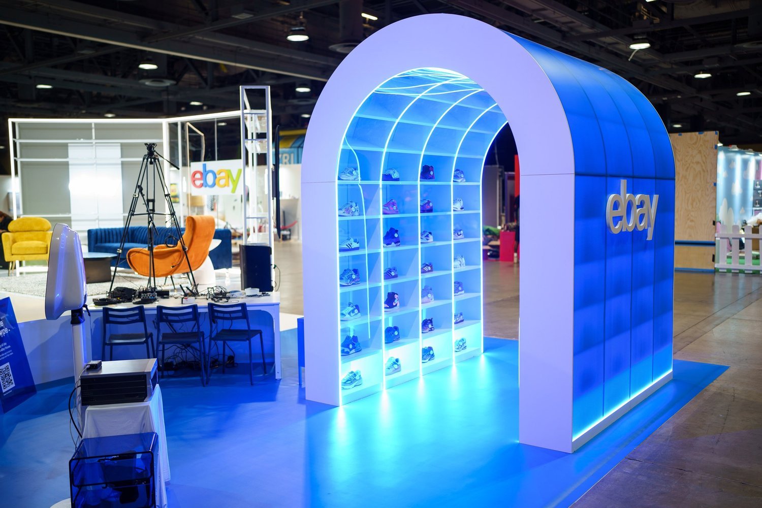 A tunnel of sneakers arched in blue light
