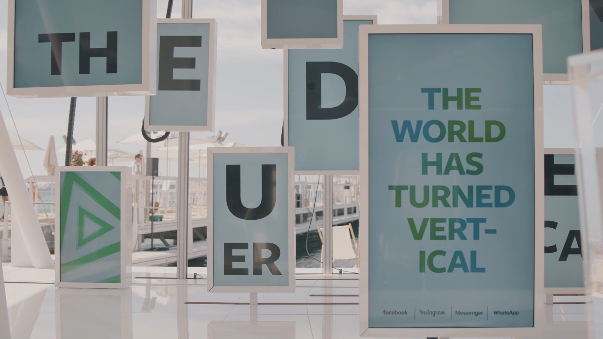 Vertical screens spelling out 'the world has turned vertical'