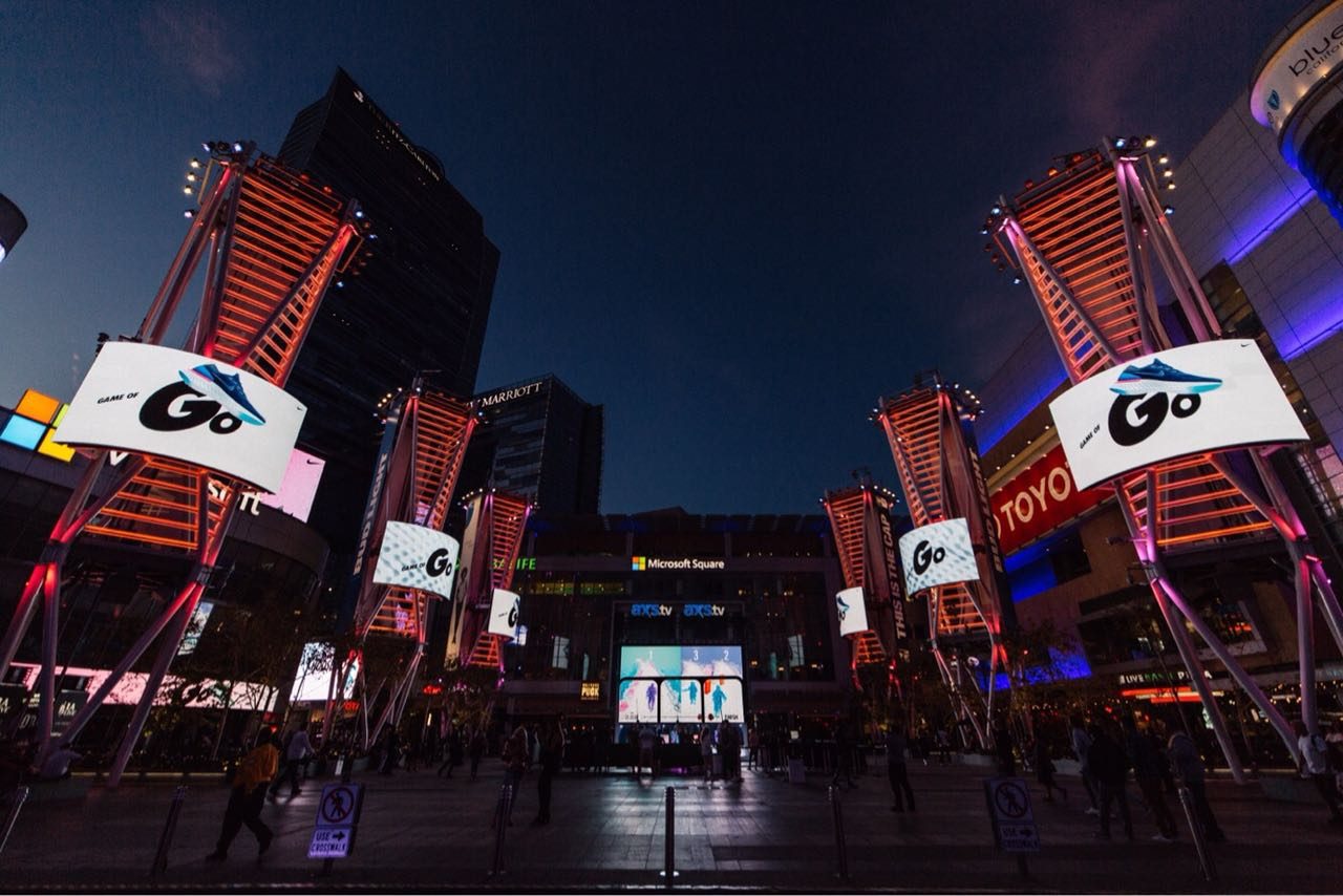 Game of Go screens towering over the L.A. Live plaza at night