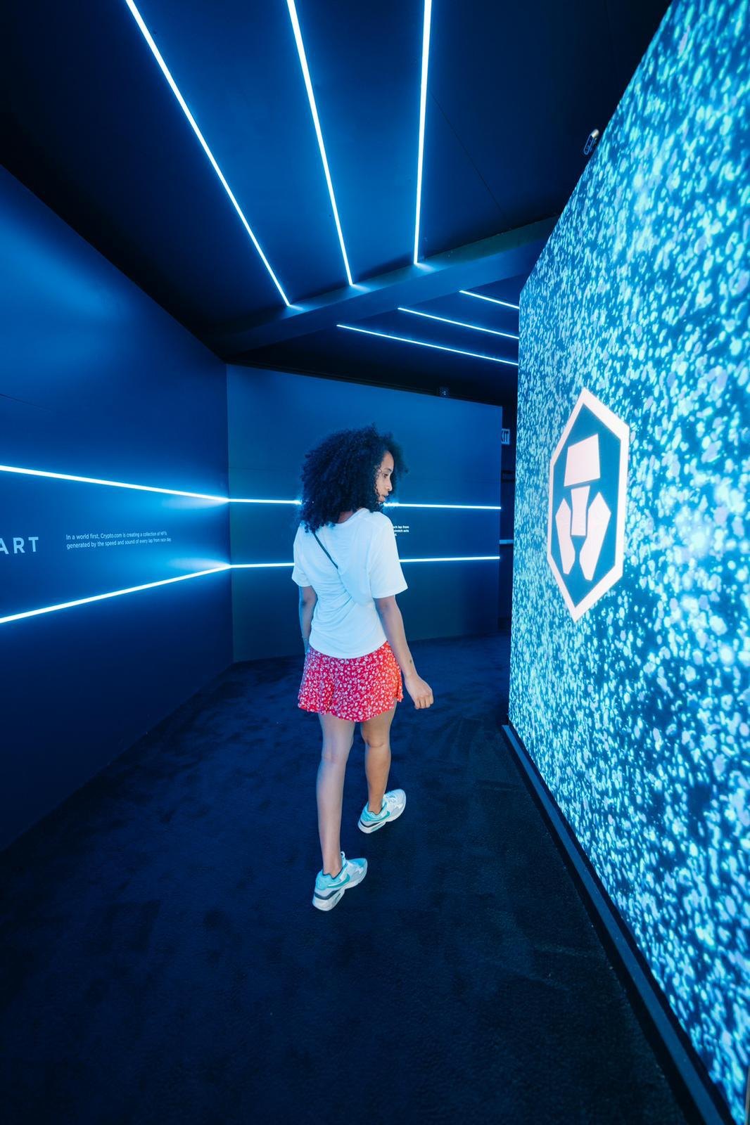 The gallery tunnel, the Crypto.com mark in particles