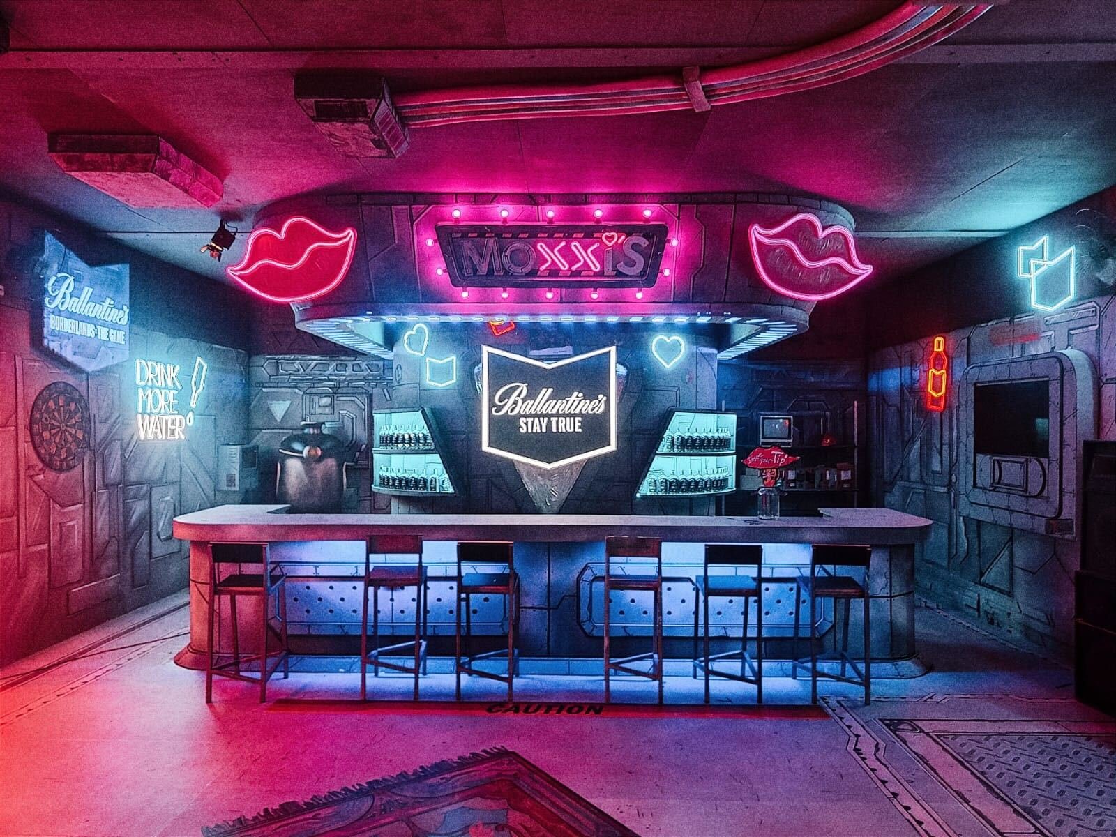 Inside Moxxi's bar, all pink and blue neon