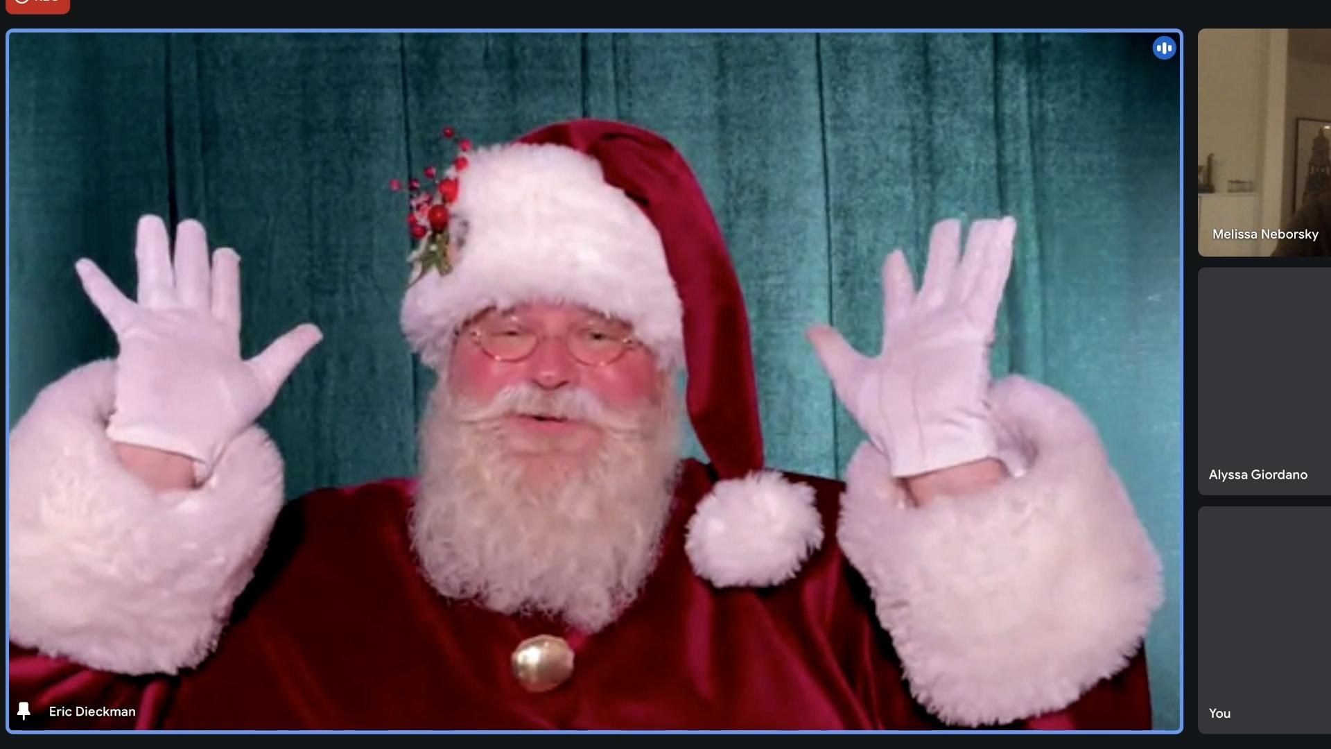 Santa greeting a family over live video