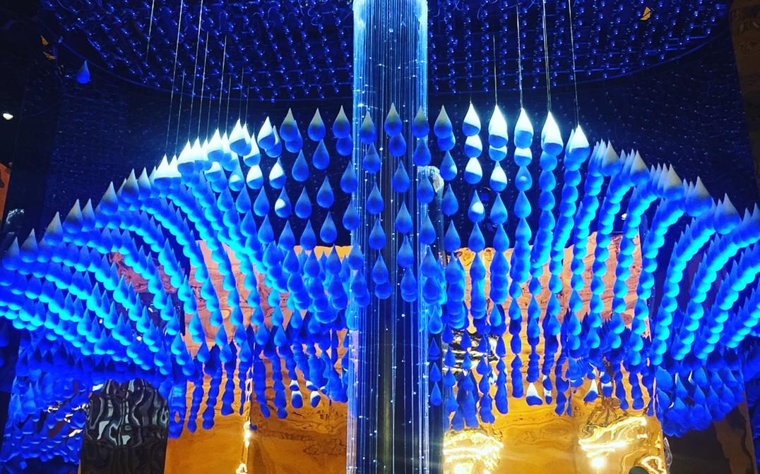 Blue water droplets suspended beneath Grand Central's ceiling