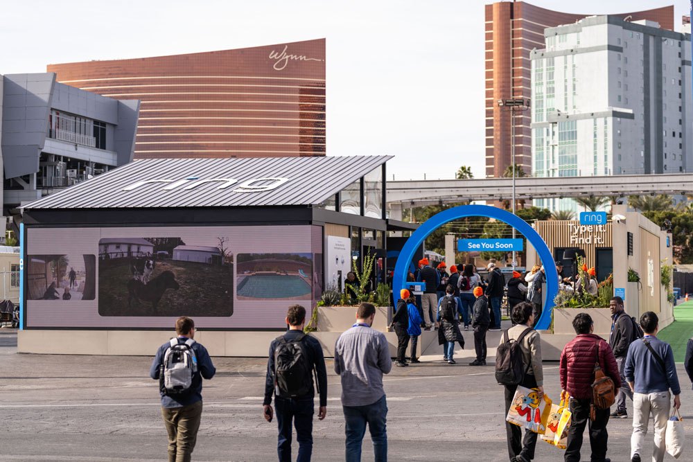 Attendees streaming toward the blue arch, the Vegas strip behind