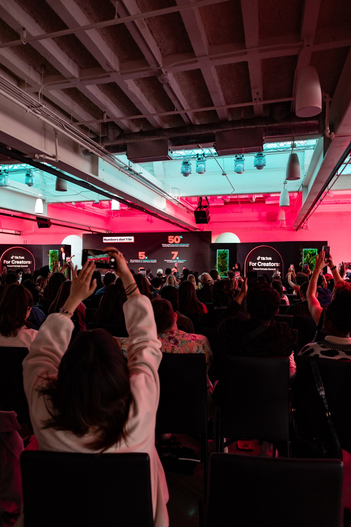 Creators raising their phones at the keynote