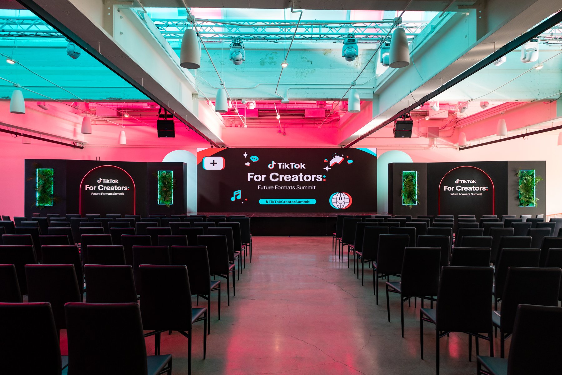 The Future Formats Summit keynote room, dressed in pink and teal