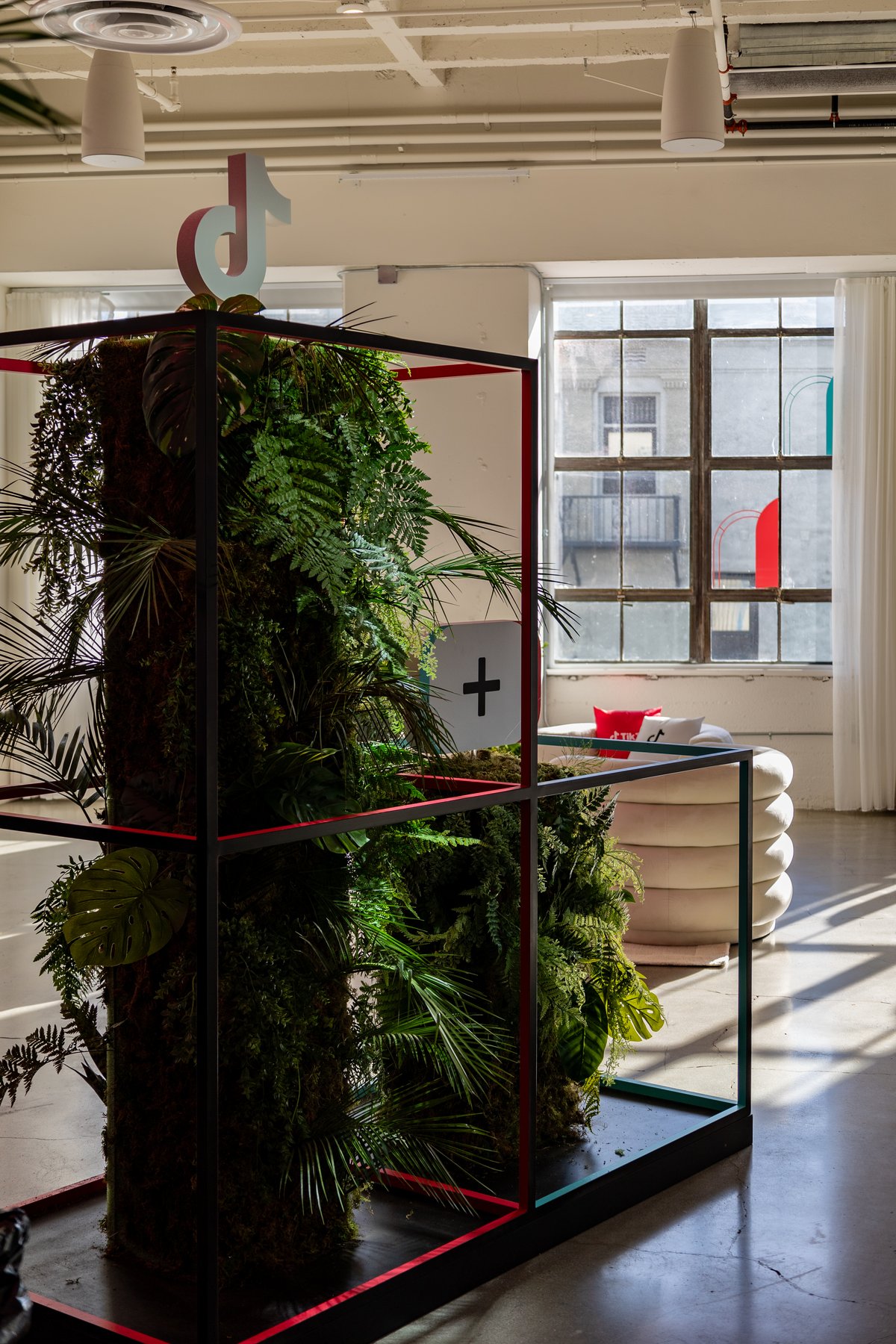A living plant totem wearing the logo