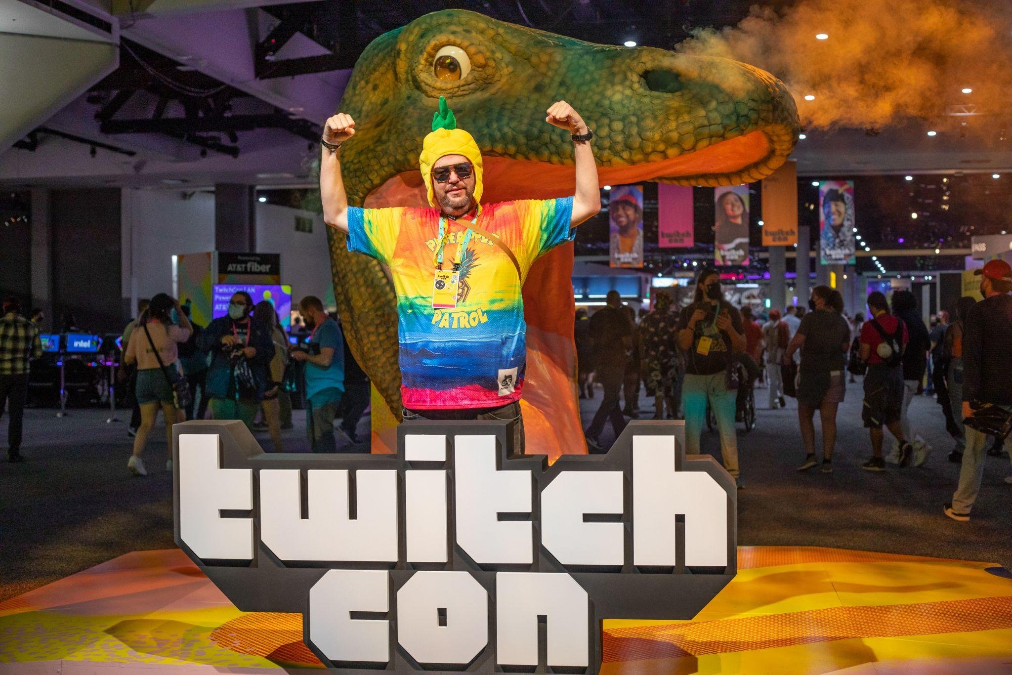 A costumed attendee posing at the TwitchCon letters